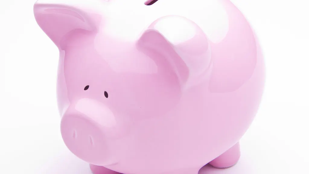 A pink ceramic piggy bank on a white background