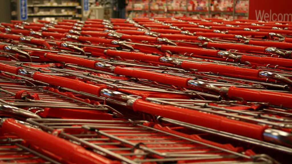 Rows of red shopping carts nested together at a store entrance