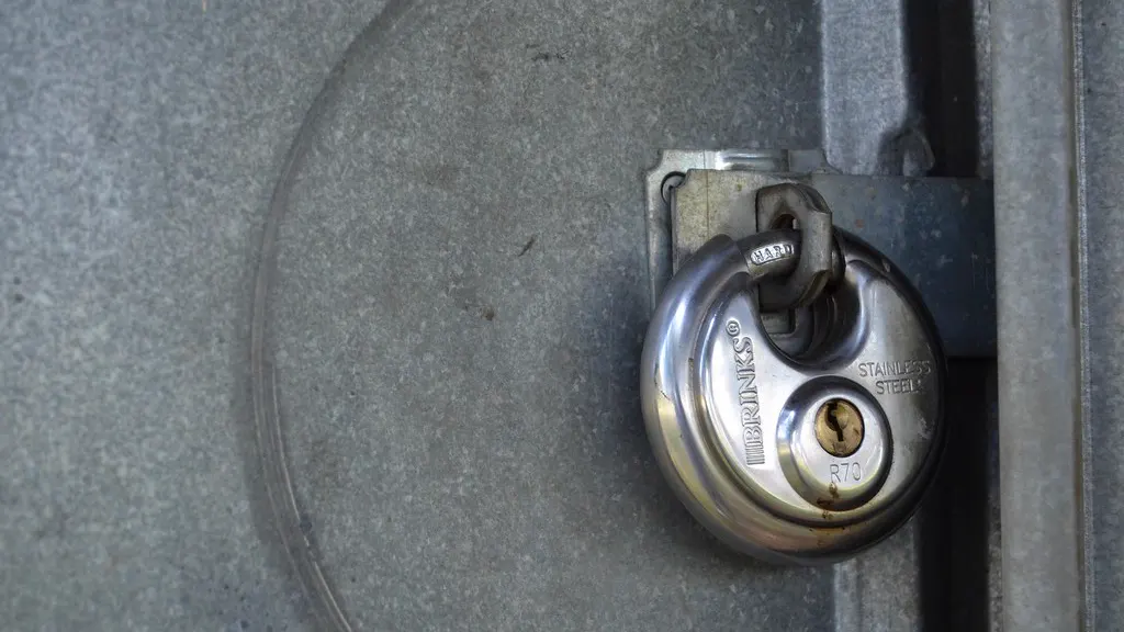 A steel padlock securing a metal door