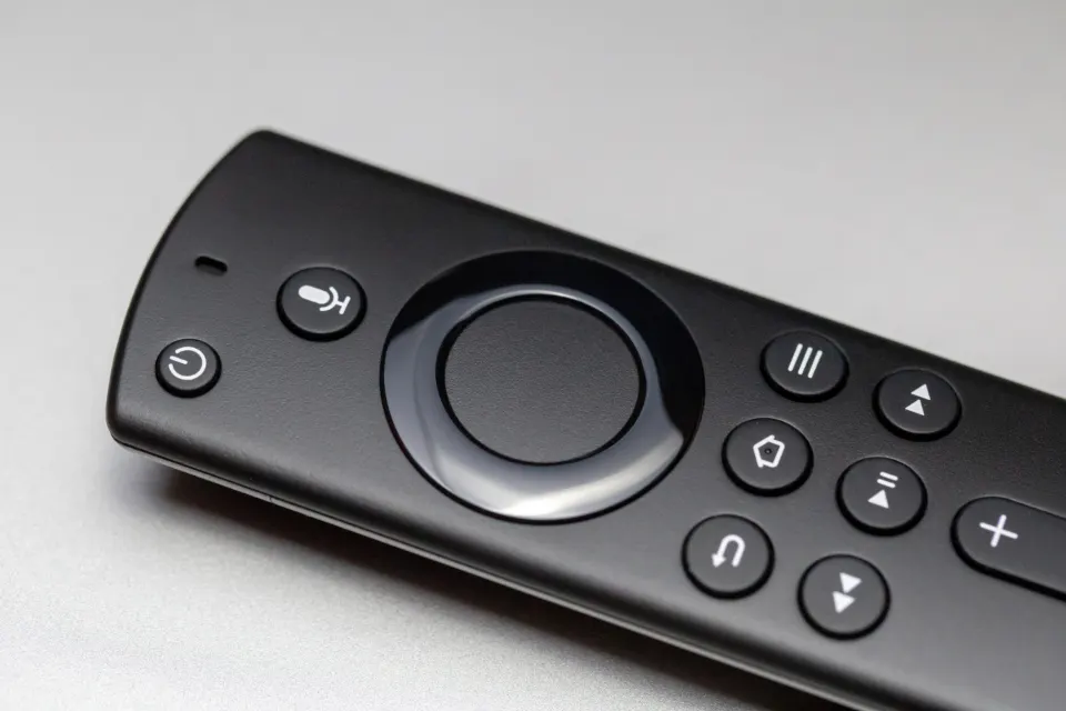 A streaming-device remote control on a grey surface