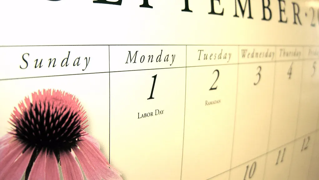 A wall calendar open to September, with Monday the 1st marked as Labour Day